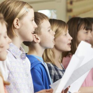 Group Of School Children Singing In School Choir